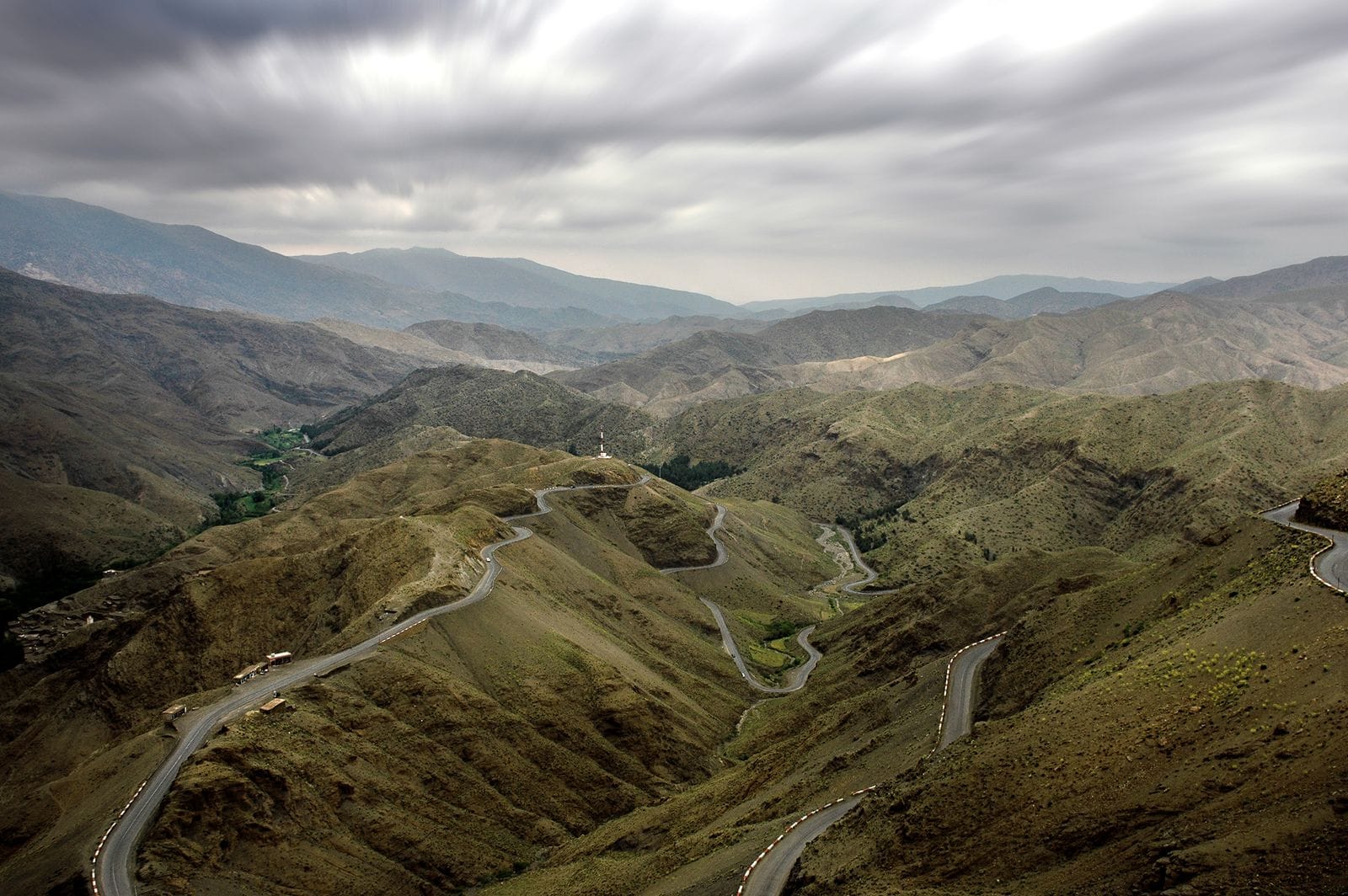 Switchback road climbing the High Atlas near Ouarzazate, where the driving days get their length