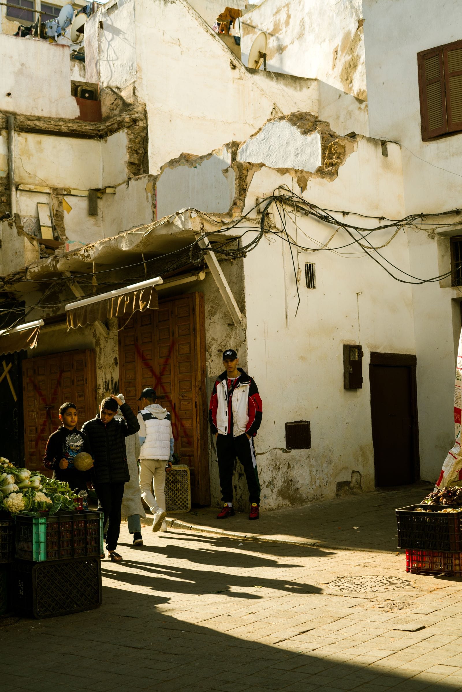 A busy Moroccan street market with stalls and shoppers, the kind of place where cards do not work