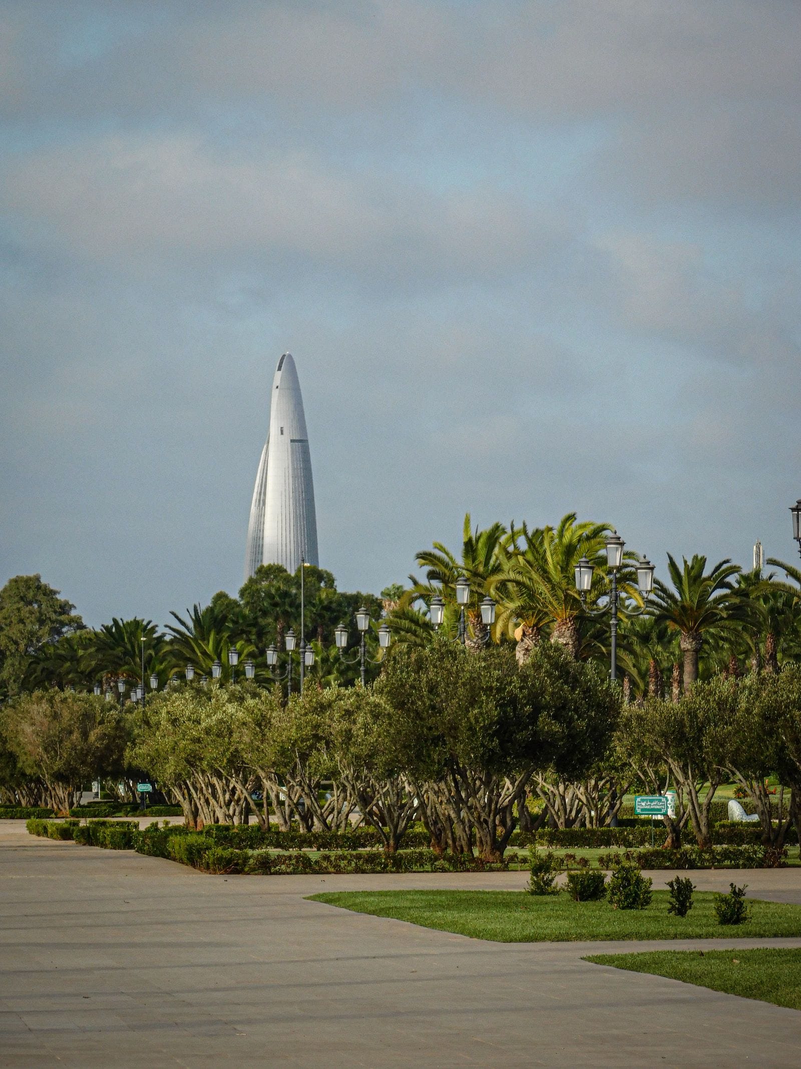 A modern tower rising behind a palm-lined park in Rabat, the greener and quieter of the three long-stay cities