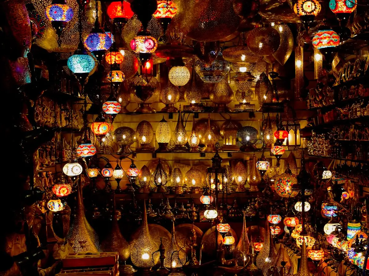 A Marrakech lantern shop lit from inside, hundreds of pierced-brass and coloured-glass lamps and not one price tag